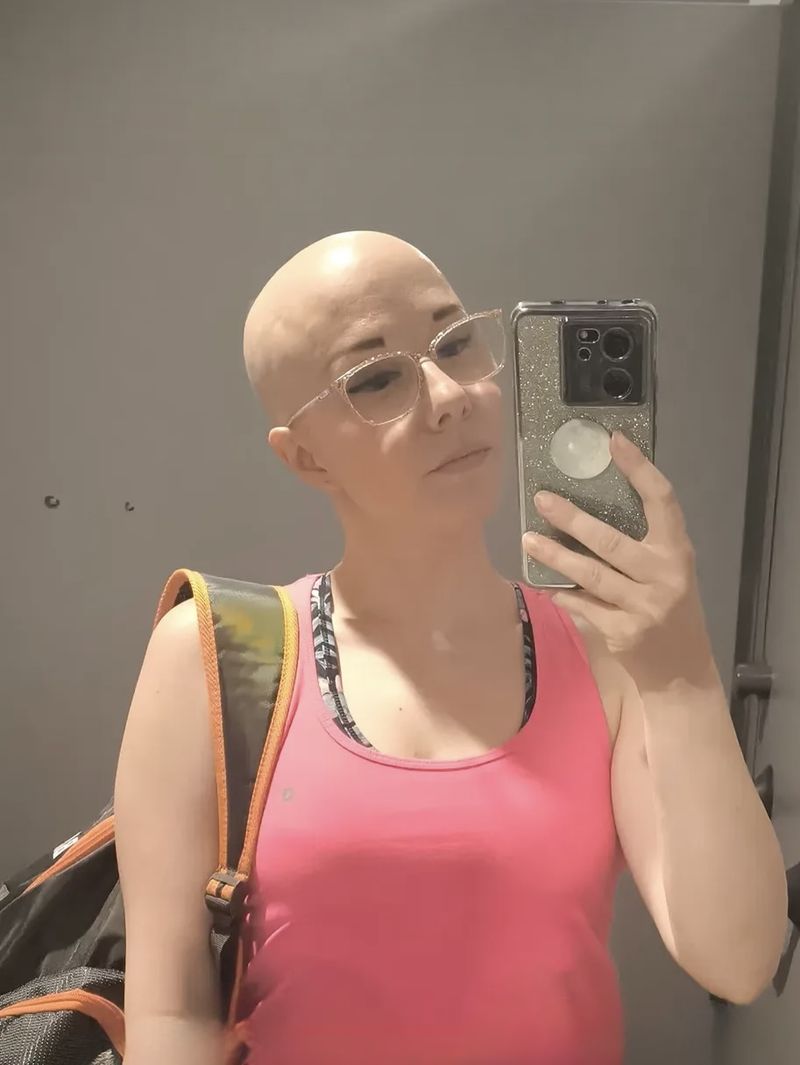 Client before her HEADS wig, mirror selfie