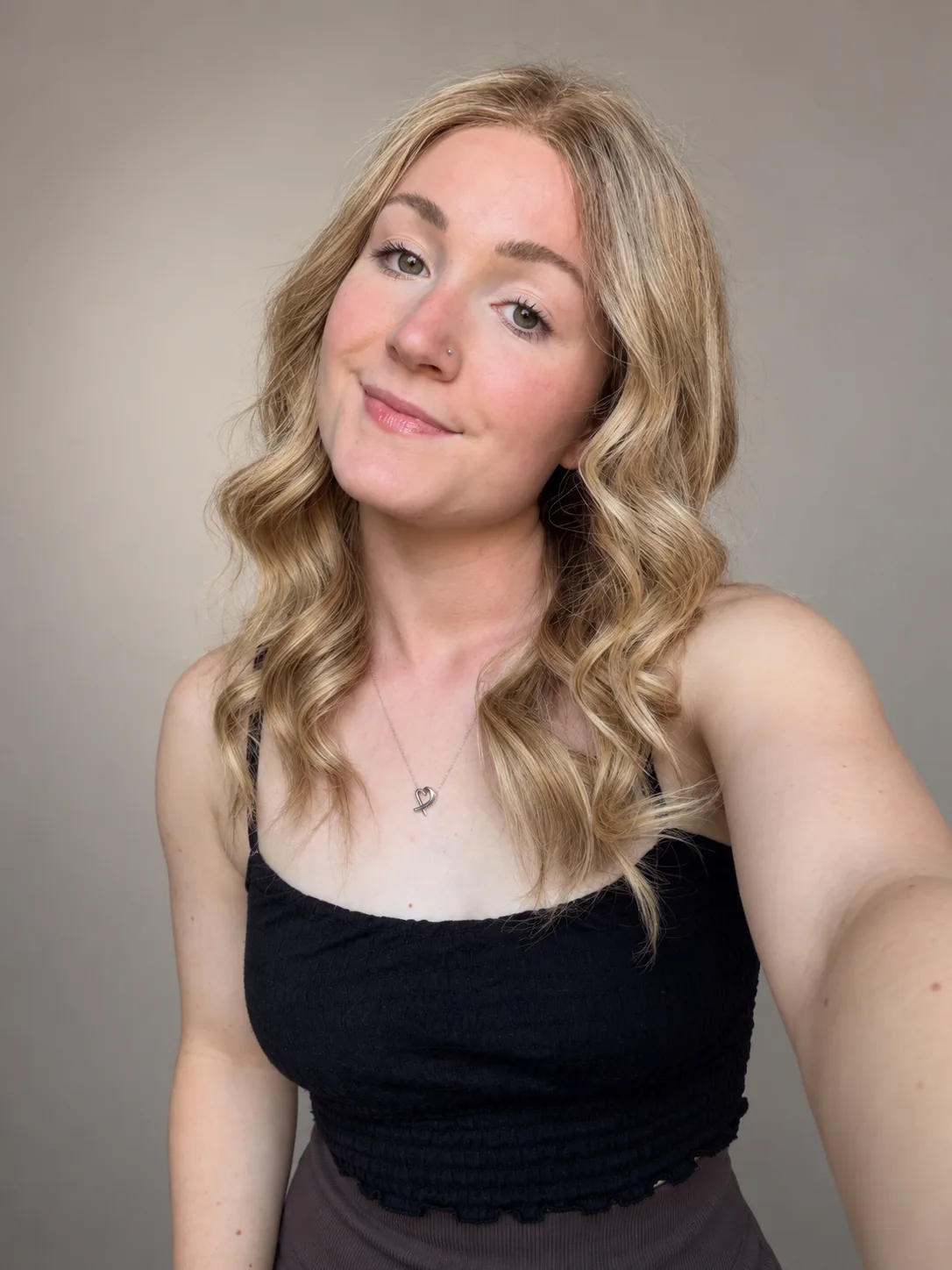 Long blonde wavy human-hair wig, studio portrait