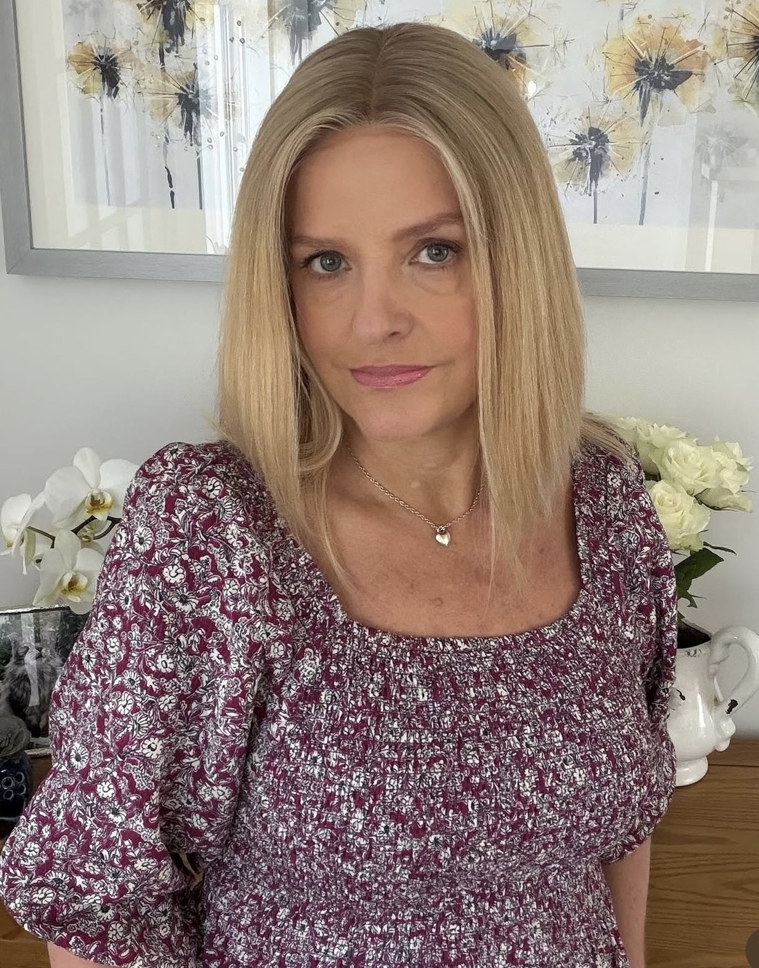 Sleek blonde lob human hair wig on a mature client