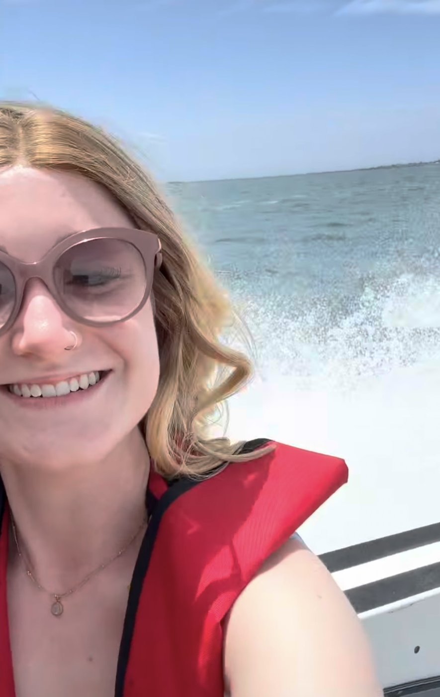 Blonde wig staying in place on a speedboat ride at sea