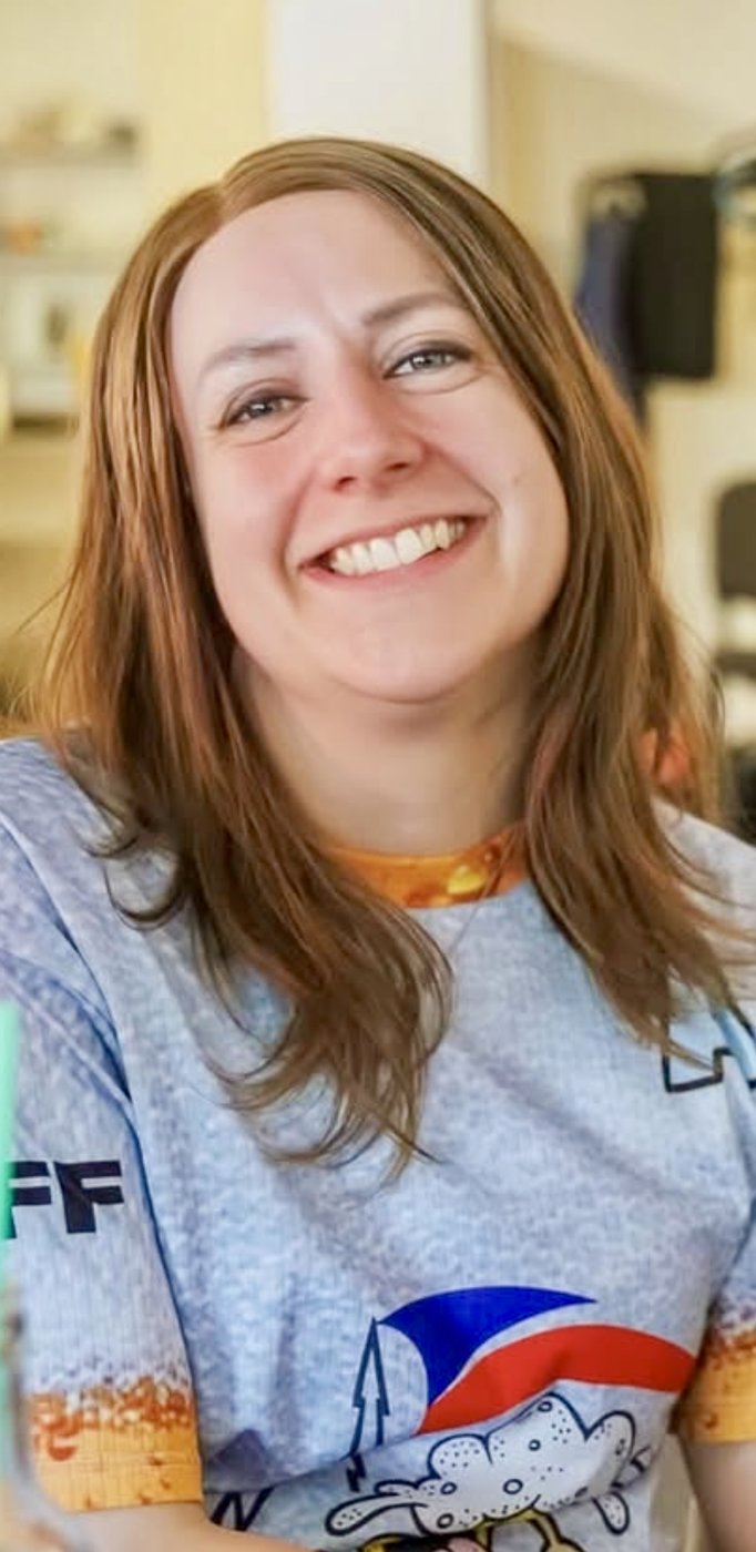 Laughing client in a natural brown human hair wig