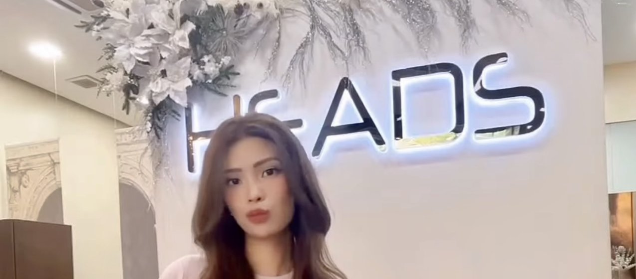 Brand Ambassador in a long layered wig at the HEADS studio in Makati