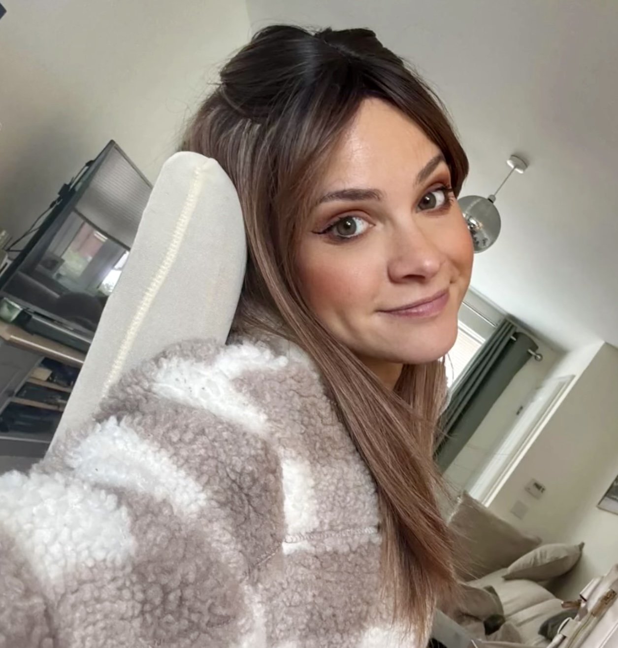 Rooted brown wig worn half-up on a cozy day at home