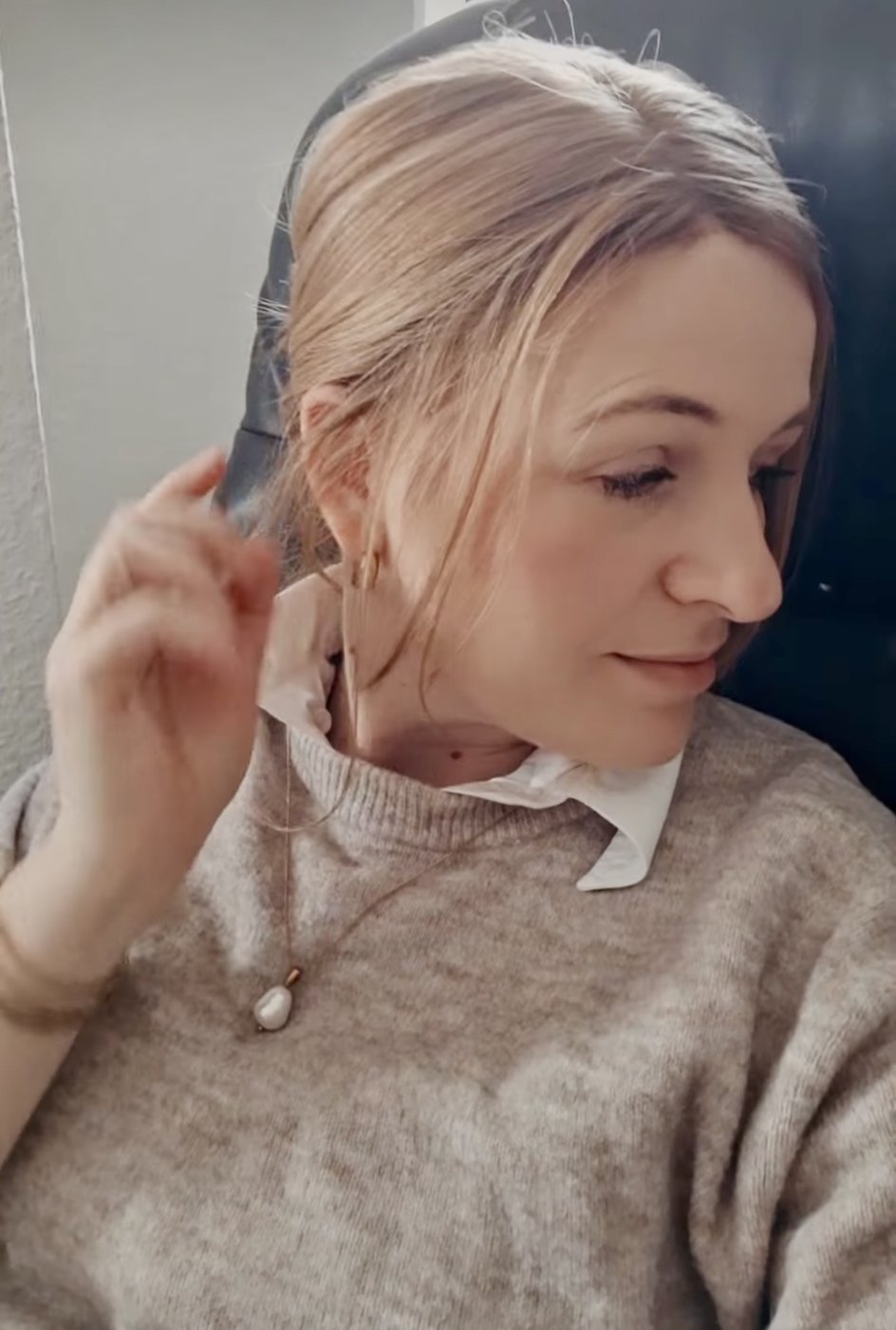 Side view of a blonde wig swept back showing the natural hairline