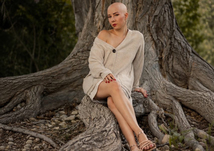 The same woman outdoors without her wig, relaxed and strong